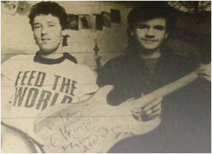 Caption: In tune…that’s Lee Partlow (right) receiving his winning guitar from Ian Gibbons