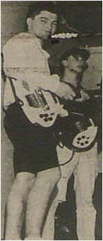 Caption: Neil Gordon smiles as the band prepare to play their set.